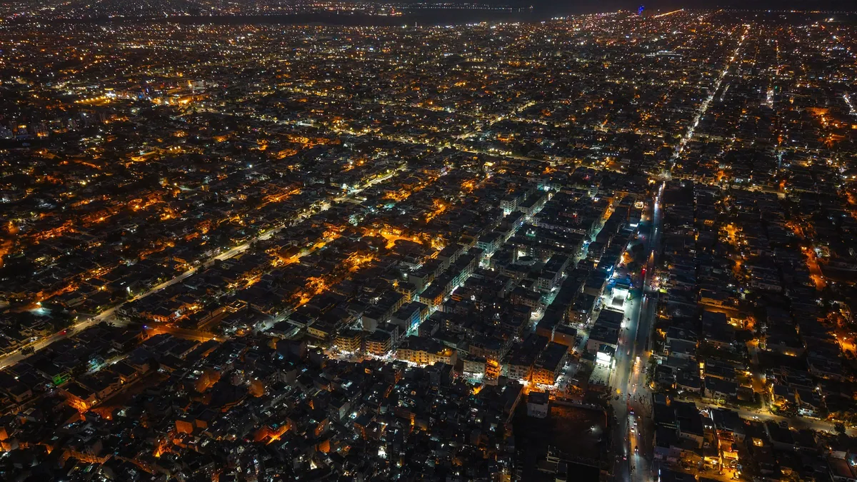 Karachi from the air at night, its streets lit in orange and white.
