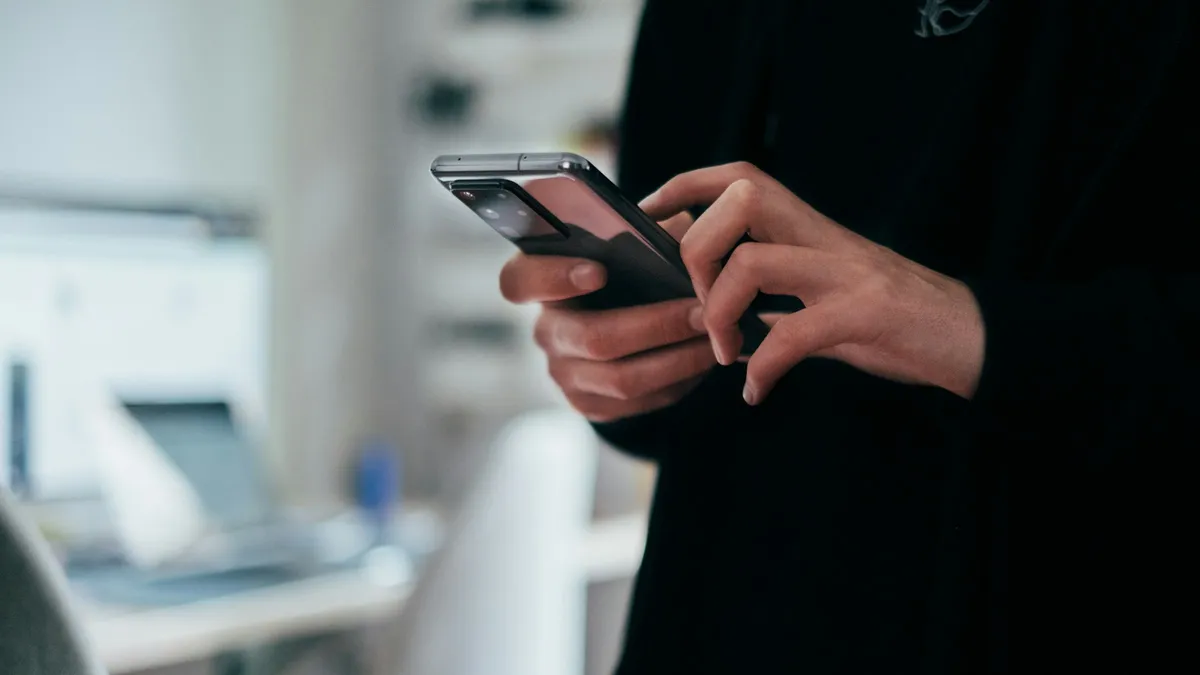 Person holding black android smartphone.