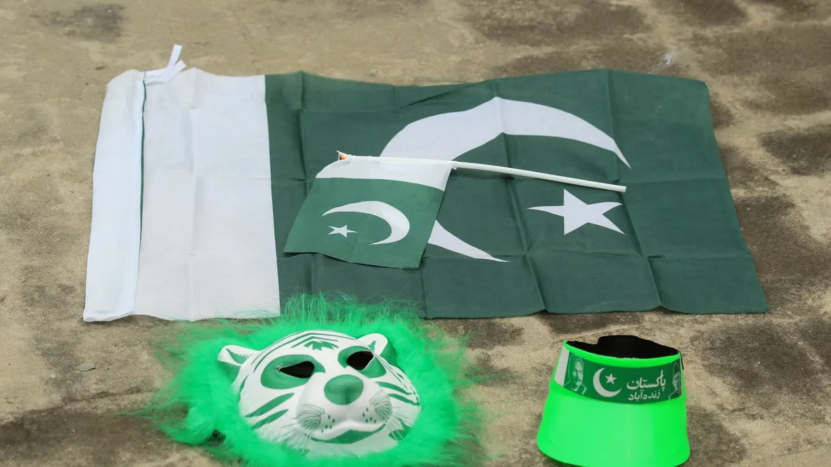 A Pakistani flag, a small handheld flag, a tiger mask, and a green visor.