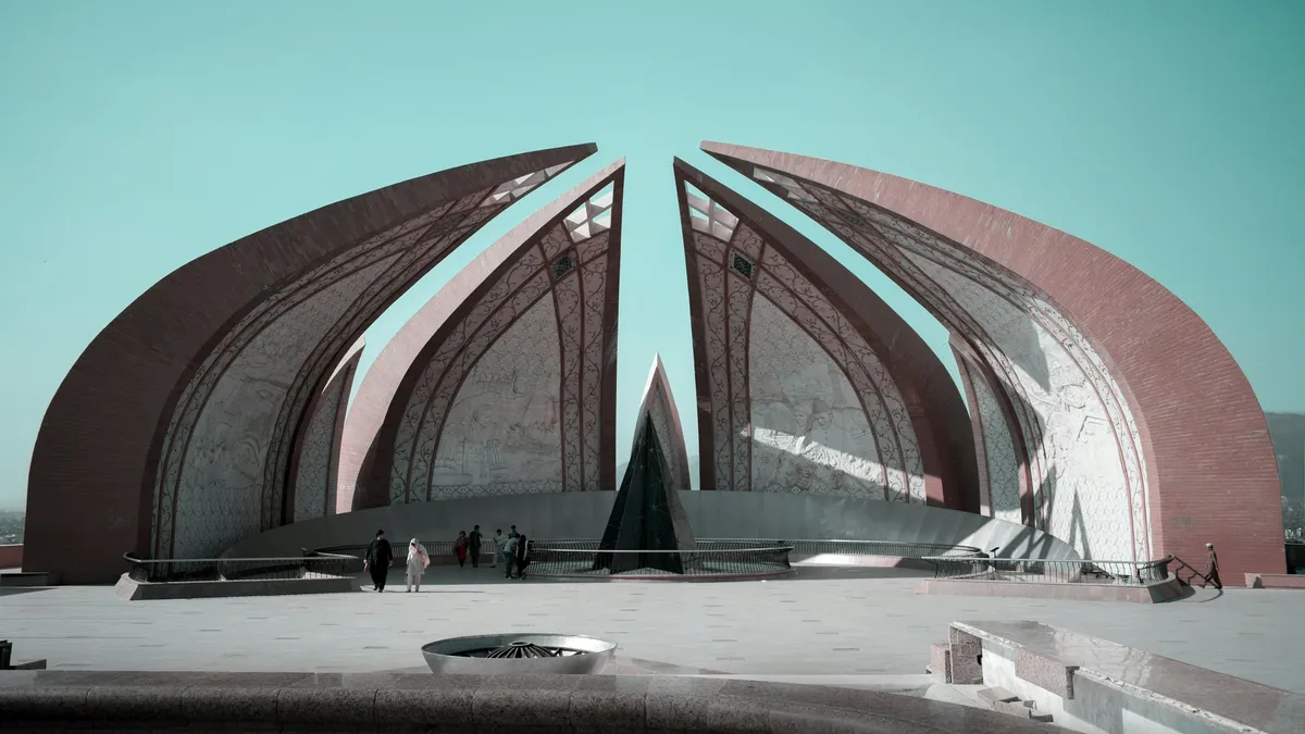 The Pakistan Monument in Islamabad, with visitors walking in front of it.