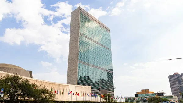 The United Nations headquarters building in New York, with flags flying.