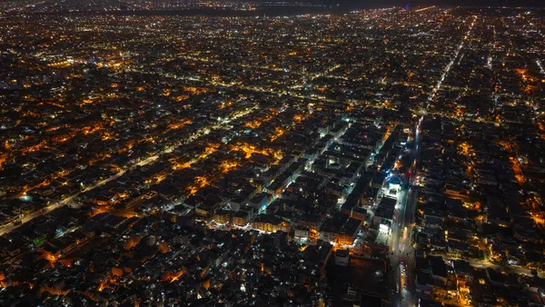 Karachi from the air at night, its streets lit in orange and white.