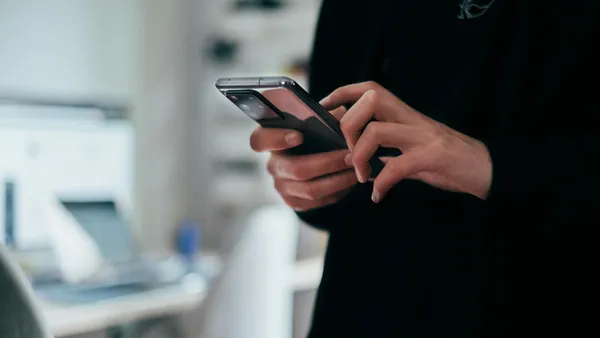 Person holding black android smartphone.